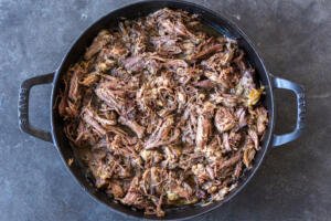 Beef pulled apart in a pan.