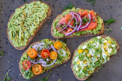 Avocado toast with different toppings.