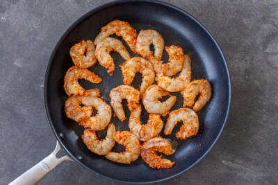 Seasoned shrimp in a pan.
