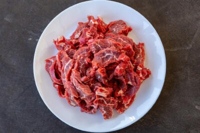 Beef sliced into thin strips.