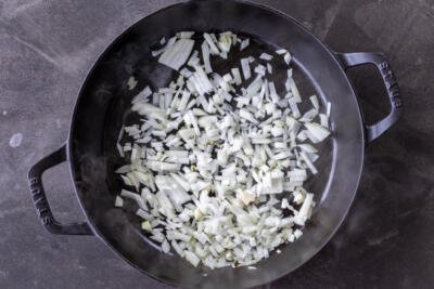 Onions cooking in a pan.