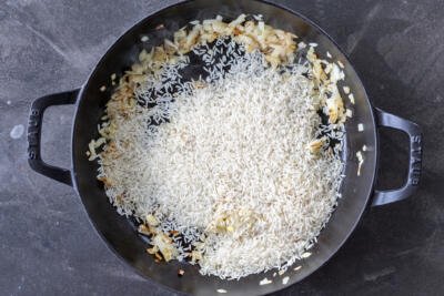 Rice added to cooking onions.