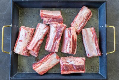 Beef short ribs on a tray.