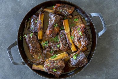 Braised Beef short ribs in a pan.