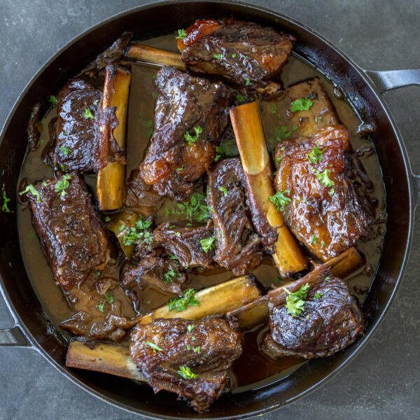 Braised Beef short ribs in a pan.