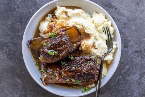 Braised Beef Short Ribs on a plate with mashed potatoes.