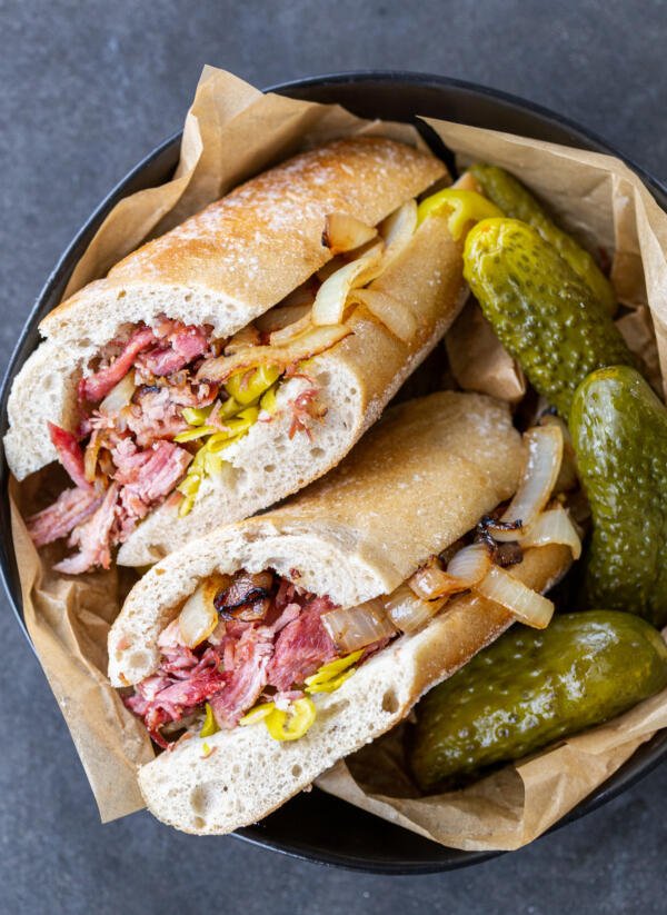 Cuban Pork Sandwich in a bowl with pickles. 