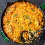 Hashbrown Breakfast Casserole in a pan with spoon.
