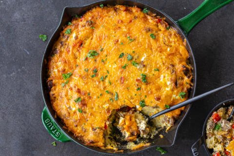 Hashbrown Breakfast Casserole in a pan with spoon.