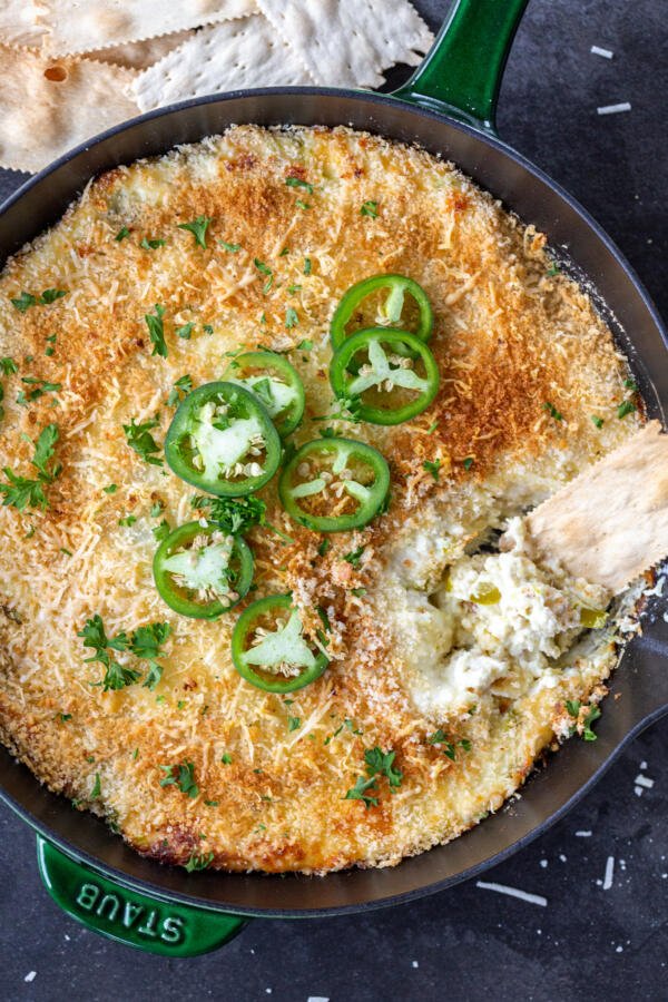 Jalapeno Popper Dip with crackers in a pan. 