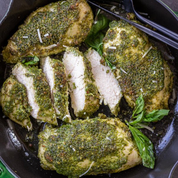 Chicken sliced into pieces on a baking pan.