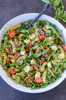 Pesto Pasta Salad with a spoon in a bowl.