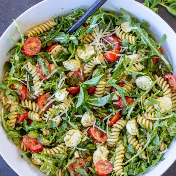 Pesto Pasta Salad with a spoon in a bowl.