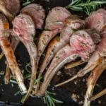 Roasted Rack of Lamb on a serving tray with rosemary.