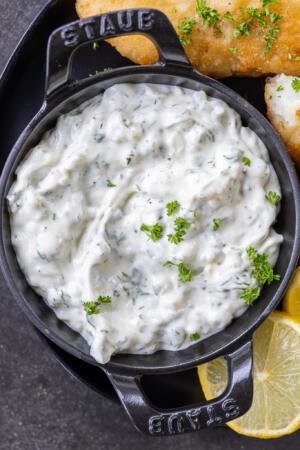tartar sauce with topped with hers in a serving dish.