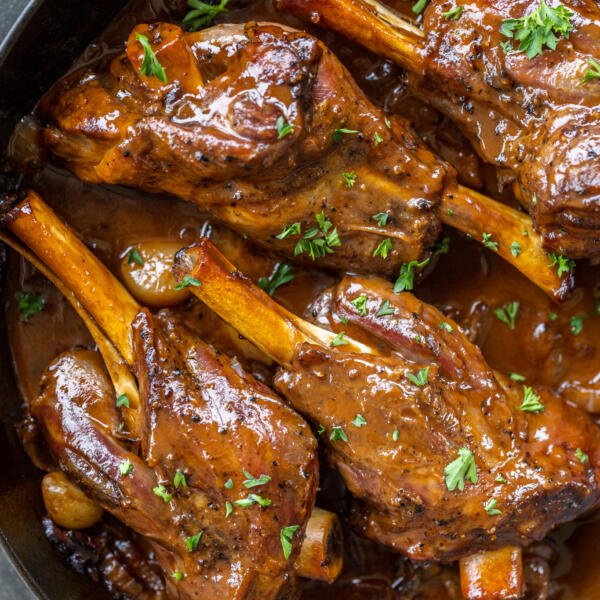 Braised Lamb Shanks in a pan.