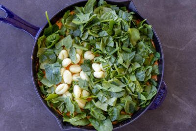 Spinach and gnocchi added to the pan.