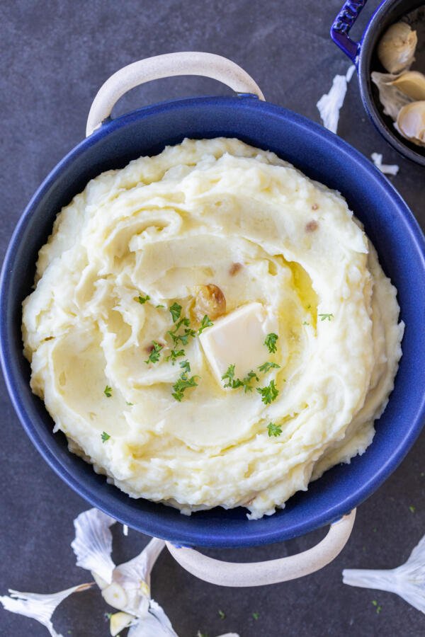 Garlic mashed potatoes in a bowl with butter. 