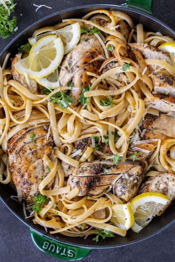 Lemon Chicken Pasta in a pan with herbs and lemon. 