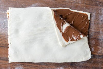 Nutella applied to puff pastry dough.