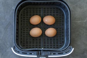 Eggs in a air fryer basket.