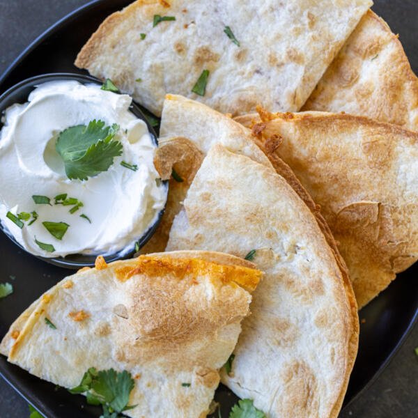 Air Fryer Quesadillas on a plate with sipping sauce.