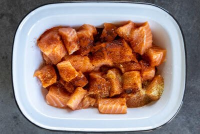Seasoned salmon bites in a serving dish.