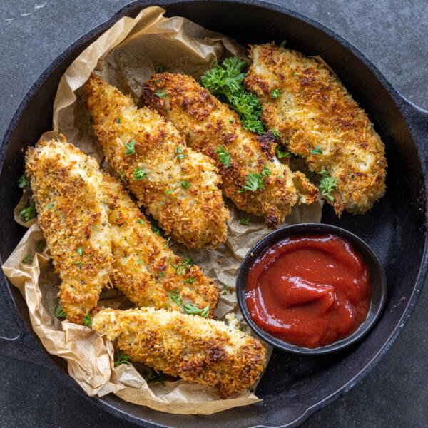 Baked chicken tenders on a pan.