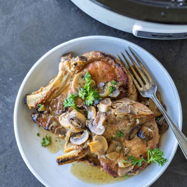 Pork Chops on a plate with mushrooms.