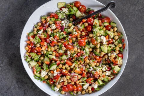 Mediterranean Chickpea Salad in a bowl with a spoon.