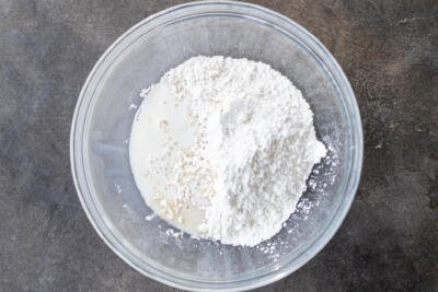 Powdered sugar with milk in a bowl.
