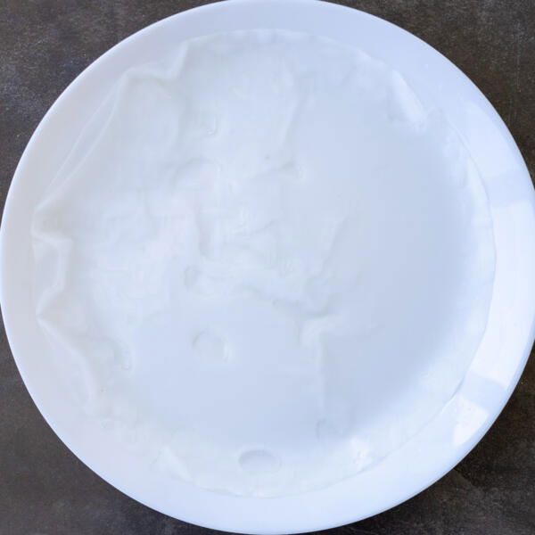 Spring roll wrappers in a water plate.