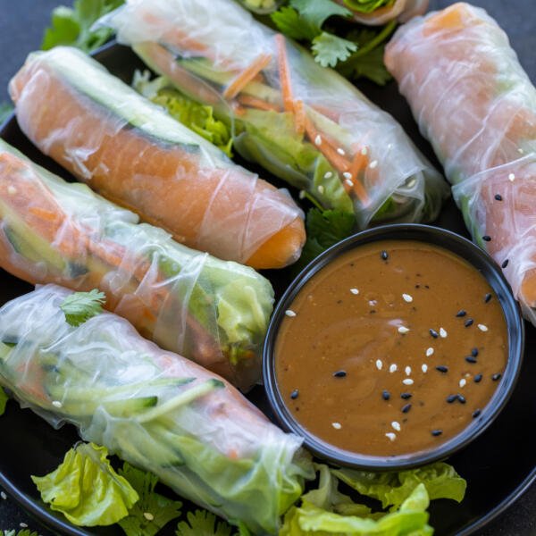 Spring Rolls With Salmon with sauce for serving.