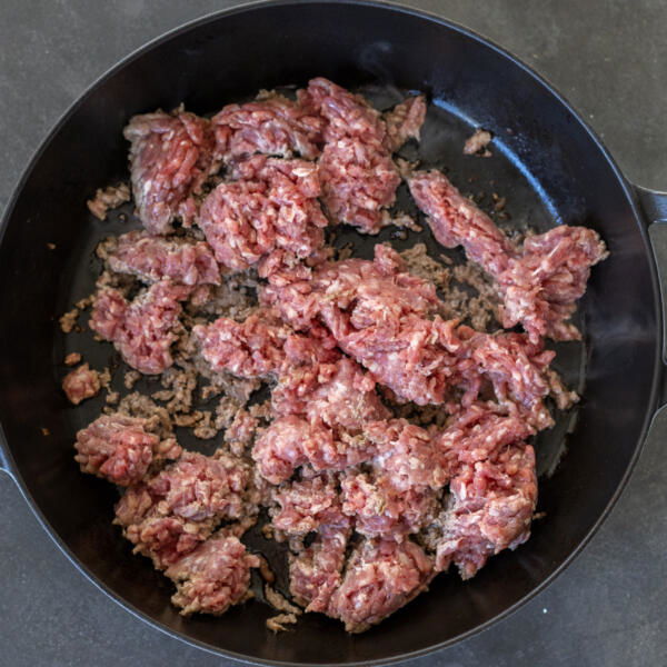 Ground beef frying in a pan.