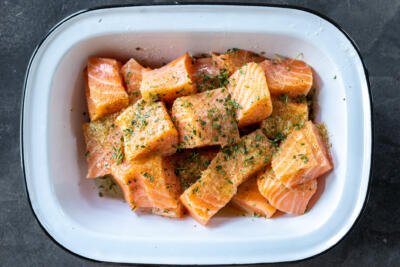 Salmon with seasoning in a bowl.