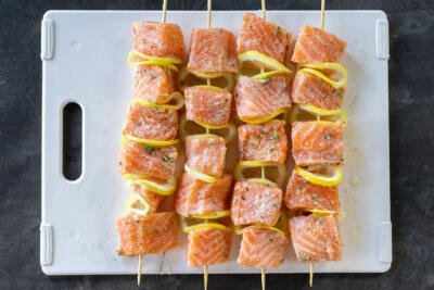 Salmon Kebabs before cooking on a tray.