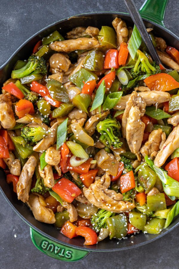 Hunan Chicken in a pan with green onions. 