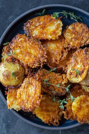 Parmesan Crusted Potatoes on a plate.