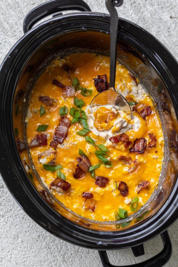 Slow Cooker Crack Chicken with bacon on top.