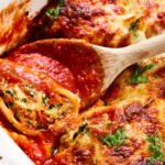 Pan with Spinach Stuffed Shells and spoon.
