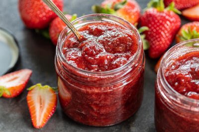 Strawberry Jam with strawberries around it.