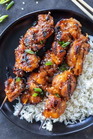 Plate with rice and Teriyaki Chicken Skewers .