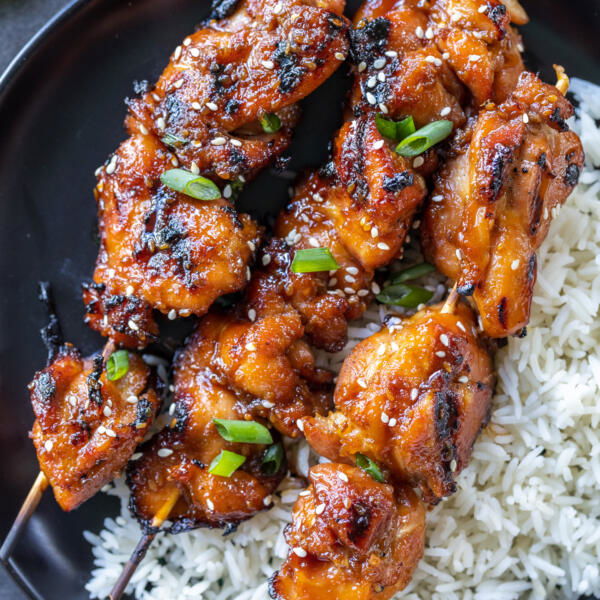 Plate with rice and Teriyaki Chicken Skewers .