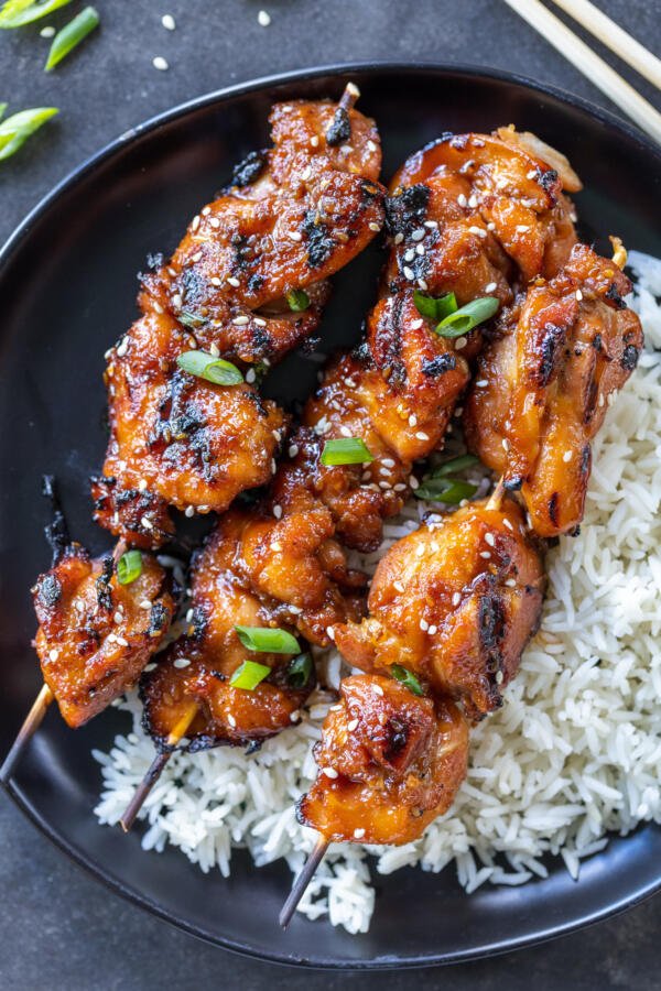 Plate with rice and Teriyaki Chicken Skewers . 