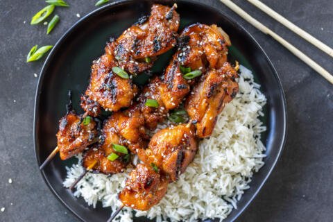 Grilled Teriyaki Chicken Skewers on a plate with rice.