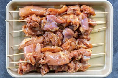 Teriyaki Chicken Skewers on a tray before cooking.