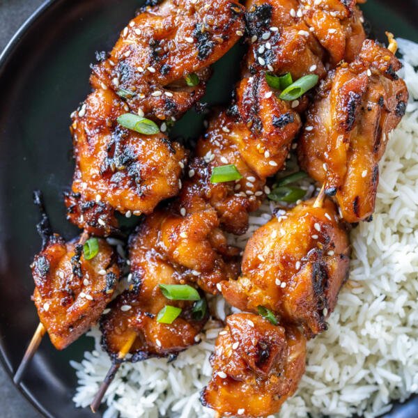 Grilled Teriyaki Chicken Skewers on a plate with rice.