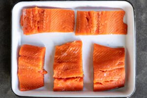 Sliced salmon on a tray.