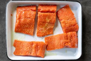 Seasoned salmon on a tray.
