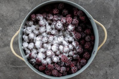 Blackberries and sugar in a pot.